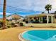 Beautiful outdoor space featuring a pool with a covered patio and desert landscaping at 502 E Fairway Rd, Henderson, NV 89015