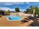 Relaxing outdoor space featuring a pool and lounge area with mature landscaping at 502 E Fairway Rd, Henderson, NV 89015