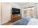 Cozy bedroom with a sliding glass door, wood dresser, and a rocking horse at 515 Kristin Ln, Henderson, NV 89011