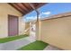 Gated front entrance to unit, with artificial turf, covered walkway, and cinder block facade at 515 Kristin Ln, Henderson, NV 89011