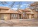 Tan townhouse-style home with brown trim, three windows, and desert landscaping beneath a partly cloudy sky at 515 Kristin Ln, Henderson, NV 89011
