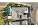 Aerial perspective showcasing a modern home's roof design and backyard pool and spa in a desert community at 5155 Rock Daisy Dr, Las Vegas, NV 89135
