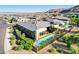 An aerial showcases a beautifully landscaped backyard with a pool, patio, and lush greenery at 5155 Rock Daisy Dr, Las Vegas, NV 89135