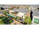 An aerial view highlights a property's well-manicured backyard, featuring a pristine pool and outdoor seating at 5155 Rock Daisy Dr, Las Vegas, NV 89135