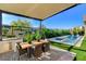 Outdoor dining area with a built-in grill and pool, perfect for entertaining friends at 5155 Rock Daisy Dr, Las Vegas, NV 89135