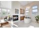 Bright bathroom features tub, fireplace, modern lighting fixture, and large windows at 5155 Rock Daisy Dr, Las Vegas, NV 89135