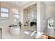 Bright bathroom featuring a modern tub, glass shower and stunning chandelier lighting at 5155 Rock Daisy Dr, Las Vegas, NV 89135