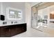 Bright bathroom featuring glass shower and a modern vanity with white countertops at 5155 Rock Daisy Dr, Las Vegas, NV 89135