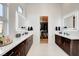 Bathroom features modern double vanity with white countertops and dark brown cabinets at 5155 Rock Daisy Dr, Las Vegas, NV 89135