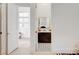 View of the bathroom with a tiled accent wall and a dark vanity at 5155 Rock Daisy Dr, Las Vegas, NV 89135