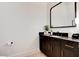 Modern bathroom featuring a black vanity with a marble countertop and sleek fixtures at 5155 Rock Daisy Dr, Las Vegas, NV 89135