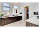 Bathroom features modern double vanity with white countertops and dark brown cabinets at 5155 Rock Daisy Dr, Las Vegas, NV 89135
