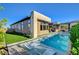 Stunning modern home with a backyard oasis, featuring a pool and lush landscaping at 5155 Rock Daisy Dr, Las Vegas, NV 89135