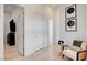 Bright hallway with light wood floors, white walls, and stylish decor accents at 5155 Rock Daisy Dr, Las Vegas, NV 89135