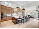 Open-concept kitchen with stainless steel appliances, an island with bar seating, and hardwood floors, great for entertaining at 5155 Rock Daisy Dr, Las Vegas, NV 89135