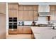 Gourmet kitchen with double ovens, granite countertops, and stainless steel appliances offering style and convenience at 5155 Rock Daisy Dr, Las Vegas, NV 89135