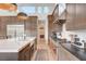 Modern kitchen with stainless steel appliances, a large island with seating, and hardwood floors offering style and functionality at 5155 Rock Daisy Dr, Las Vegas, NV 89135
