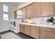 Well-organized laundry room boasts ample cabinet space and modern washer and dryer set at 5155 Rock Daisy Dr, Las Vegas, NV 89135
