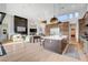 Open-concept layout with a modern fireplace, wet bar, and kitchen island with a beautiful design and seamless flow at 5155 Rock Daisy Dr, Las Vegas, NV 89135