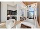 Modern living area with a wet bar, natural light, and stylish decor at 5155 Rock Daisy Dr, Las Vegas, NV 89135