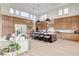 Open-concept kitchen and living room with modern lighting, hardwood floors, and a sleek design, creating a seamless flow at 5155 Rock Daisy Dr, Las Vegas, NV 89135
