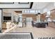 Open-concept living space featuring a modern kitchen, dining area, and comfortable living room with large windows at 5155 Rock Daisy Dr, Las Vegas, NV 89135