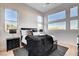Bedroom with large windows offering city views, a black accent rug and stylish furnishings at 5155 Rock Daisy Dr, Las Vegas, NV 89135
