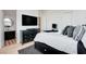 Bedroom featuring a large bed, dark wood furniture, and an ensuite bathroom at 5155 Rock Daisy Dr, Las Vegas, NV 89135