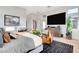 Relaxing main bedroom with a large bed, fireplace, modern furniture, and view of a big screen television at 5155 Rock Daisy Dr, Las Vegas, NV 89135