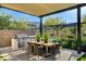 Outdoor dining area with a large table and grill, perfect for backyard entertaining at 5155 Rock Daisy Dr, Las Vegas, NV 89135