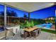 Outdoor kitchen with grill and dining area overlooking a sparkling pool, perfect for alfresco dining and entertaining at 5155 Rock Daisy Dr, Las Vegas, NV 89135