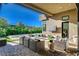 Outdoor living area with comfortable seating around a fire pit, overlooking the pool at 5155 Rock Daisy Dr, Las Vegas, NV 89135