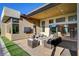 Beautiful outdoor patio with stone fire pit, ample seating, and a seamless transition to indoor living at 5155 Rock Daisy Dr, Las Vegas, NV 89135