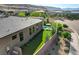 Side view of backyard pool, lawn, and home exterior in a desert-landscaped residential community at 5155 Rock Daisy Dr, Las Vegas, NV 89135