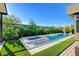 Backyard pool and spa area are surrounded by artificial turf and lush landscaping at 5155 Rock Daisy Dr, Las Vegas, NV 89135