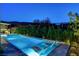 Inviting pool and spa area with desert landscaping and a covered outdoor kitchen and dining space at 5155 Rock Daisy Dr, Las Vegas, NV 89135