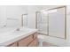 Bathroom features vanity, toilet, and glass-enclosed shower-over-tub at 5513 Escallonia St, Las Vegas, NV 89149