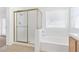 Bathroom with tile flooring, bathtub with shower and glass doors at 5513 Escallonia St, Las Vegas, NV 89149