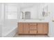 Bright bathroom with dual vanity, a large mirror, and bathtub at 5513 Escallonia St, Las Vegas, NV 89149
