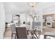 Dining area with modern chandelier, open to the staged living room and a bright kitchen at 5513 Escallonia St, Las Vegas, NV 89149