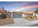 Charming single-story home featuring a desert landscape, tile roof, and attached two-car garage at 5513 Escallonia St, Las Vegas, NV 89149