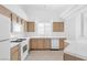 Kitchen with white appliances, tile countertops and wooden cabinets at 5513 Escallonia St, Las Vegas, NV 89149