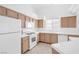 Bright kitchen with white appliances, tile countertops and wooden cabinets at 5513 Escallonia St, Las Vegas, NV 89149
