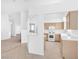 View of the kitchen with wooden cabinets, white appliances and tile flooring at 5513 Escallonia St, Las Vegas, NV 89149