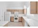 Bright kitchen featuring white appliances, tile countertops and wooden cabinets at 5513 Escallonia St, Las Vegas, NV 89149