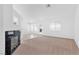 Bright living space with a fireplace, tiled floor, and sliding glass door to backyard patio at 5513 Escallonia St, Las Vegas, NV 89149