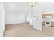 Bright living room featuring tile flooring and view into the kitchen with wooden cabinets at 5513 Escallonia St, Las Vegas, NV 89149