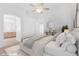 Staged main bedroom with ceiling fan, ensuite bathroom, and decor at 5513 Escallonia St, Las Vegas, NV 89149