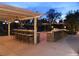 Custom backyard featuring a large granite bar, outdoor kitchen and mature landscaping, perfect for outdoor gatherings at 5854 Sheila Ave, Las Vegas, NV 89108