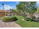 Lush backyard featuring a water fountain, artificial grass, brick work, and a serene outdoor ambiance at 5854 Sheila Ave, Las Vegas, NV 89108